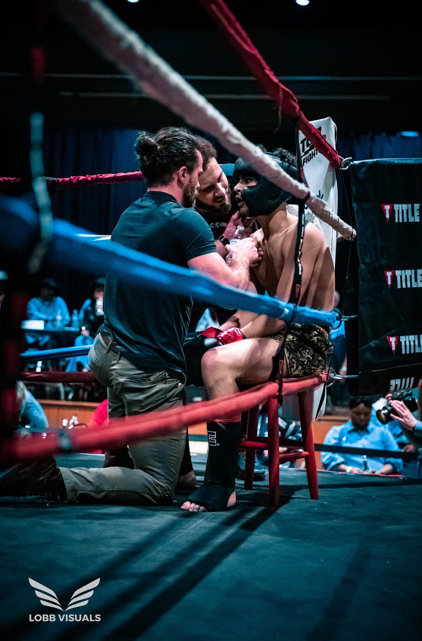 Coach working with a Tupelo Jiu Jitsu Academy fighter during an MMA competition