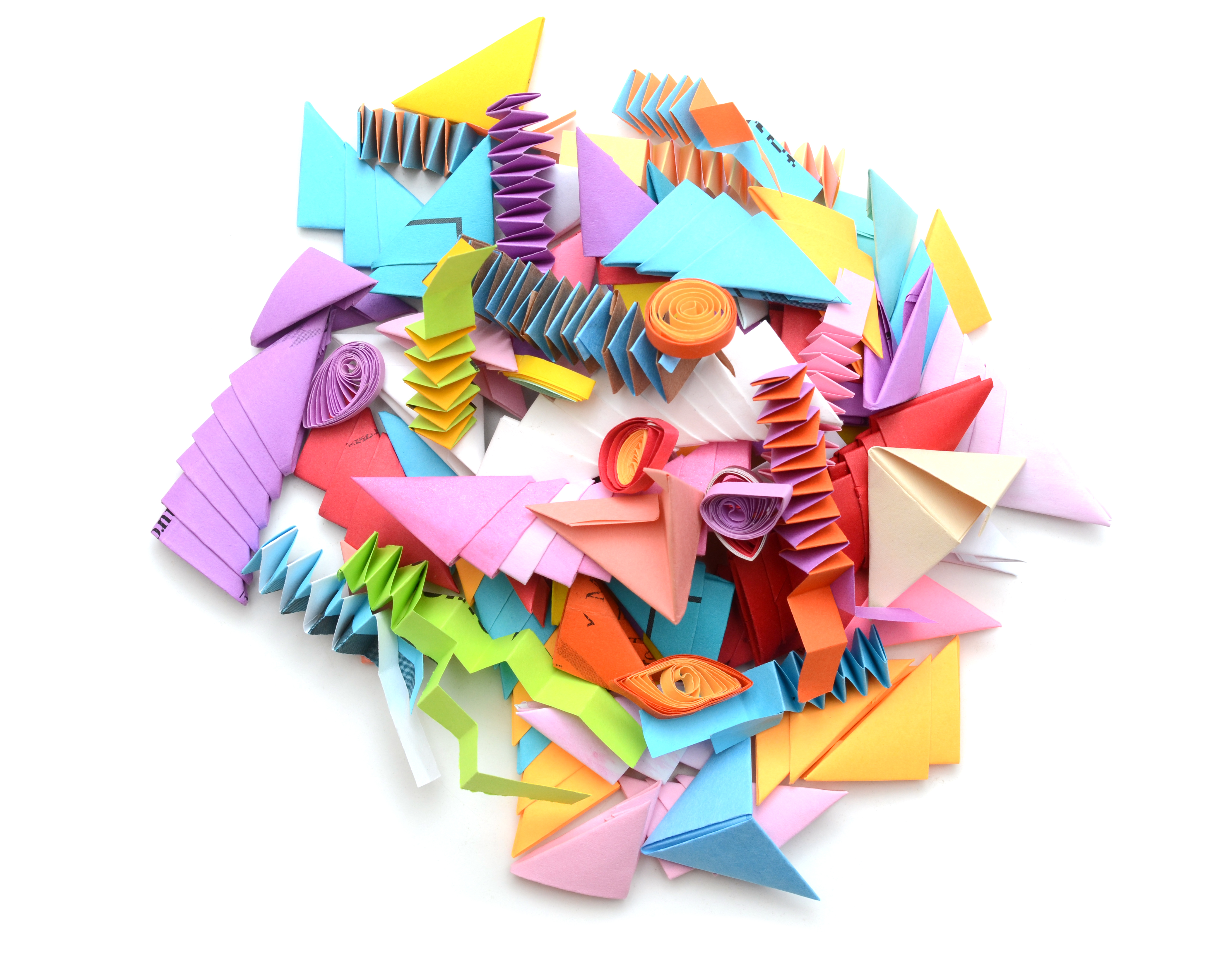 A pile of brightly coloured paper coils, concertinas, nd corners.