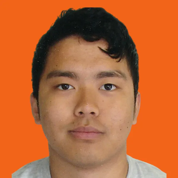 Sujan, a man of South East Asian descent, with dark hair and a light t-shirt, looks directly to camera. 