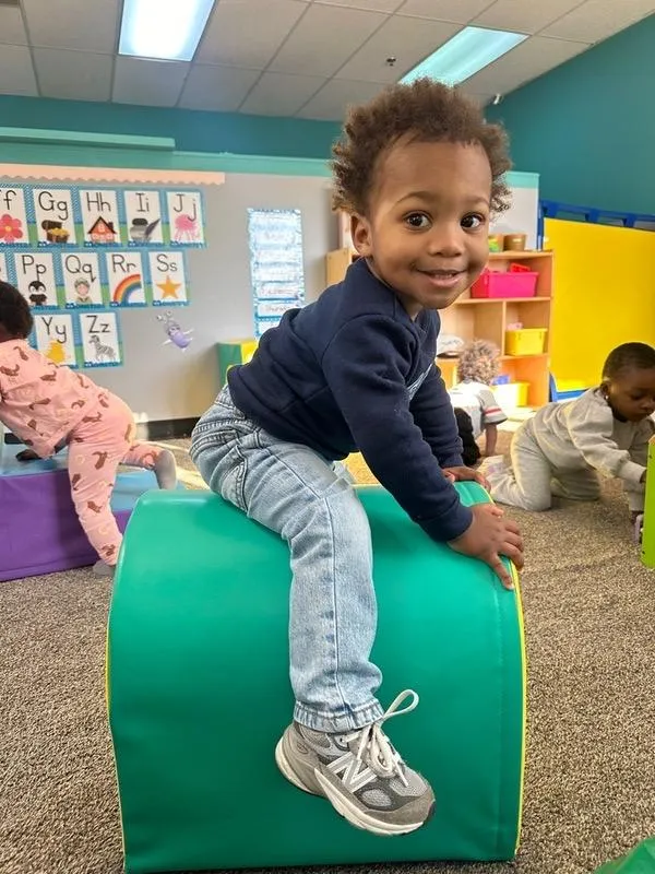 Child smiling while actively sing cognitive skills