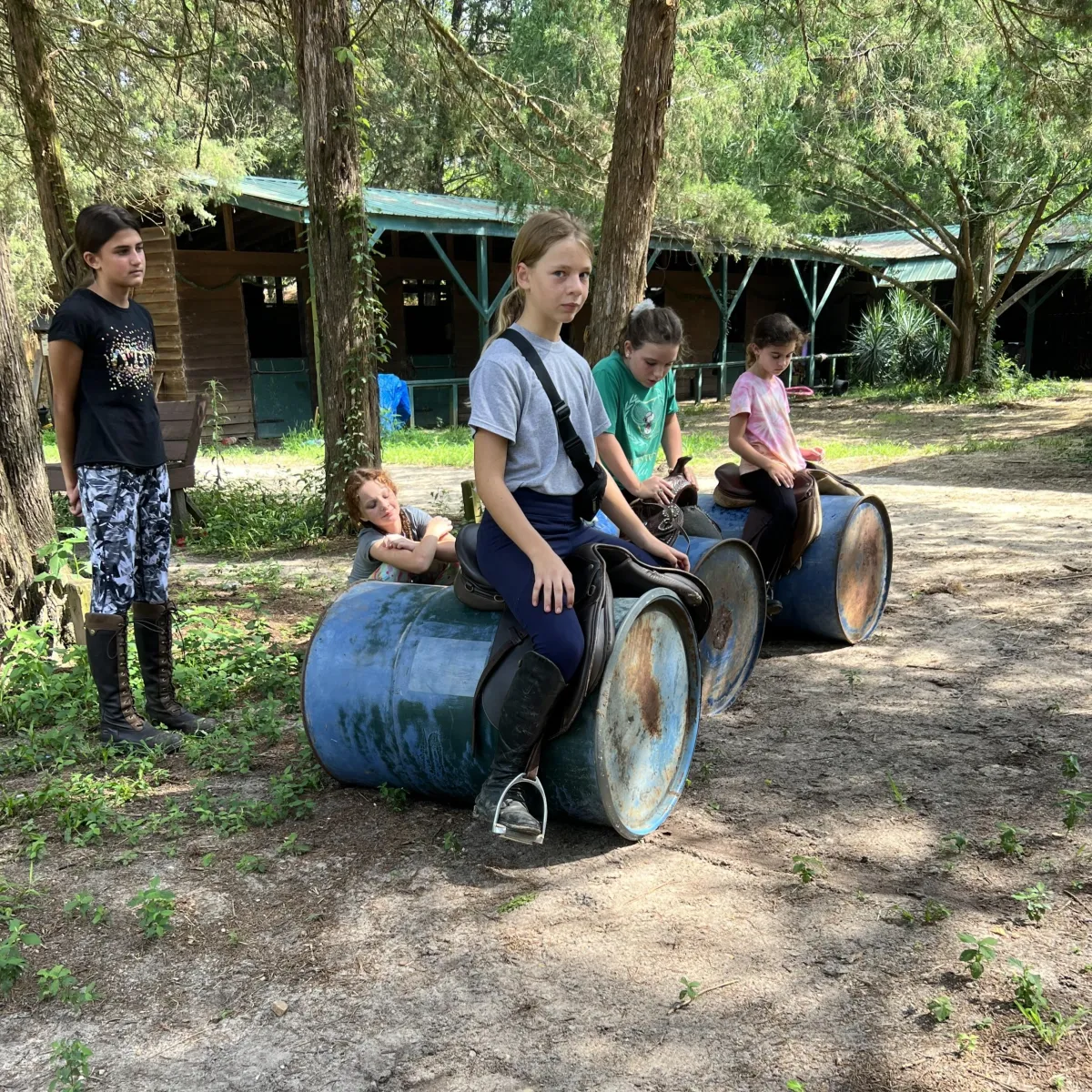 Campers participating in supervised barn skill-building activity during Spring Break Horse Camp