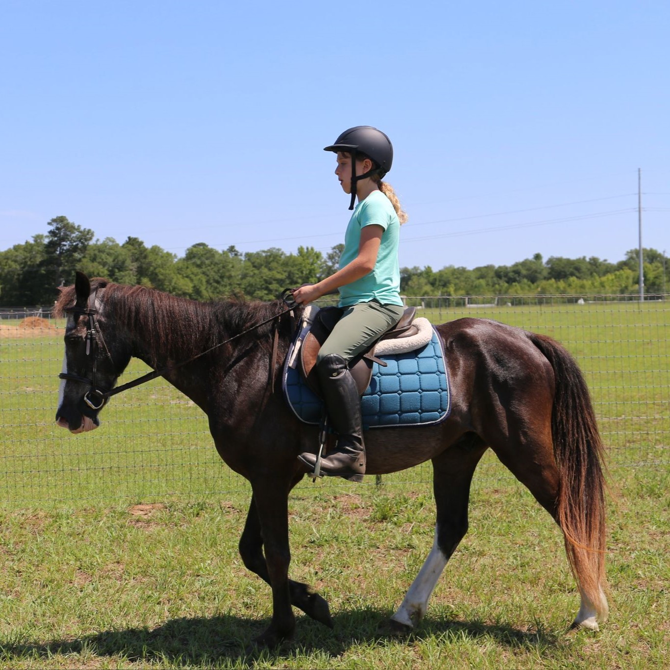 Girl is riding english on a trail ride