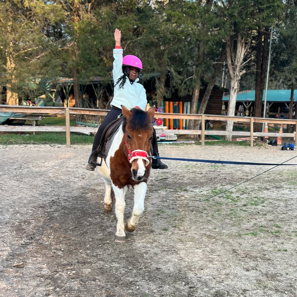 Little girl is loving her lessons pony 