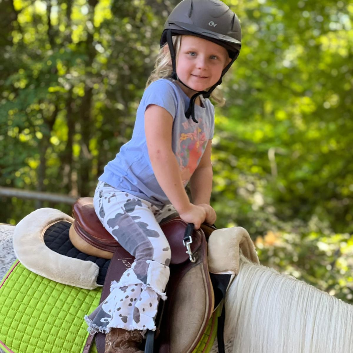 Tiny Tot girl is loving her lessons pony 
