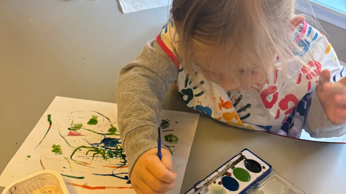 Girl follows directions during arts and crafts time.