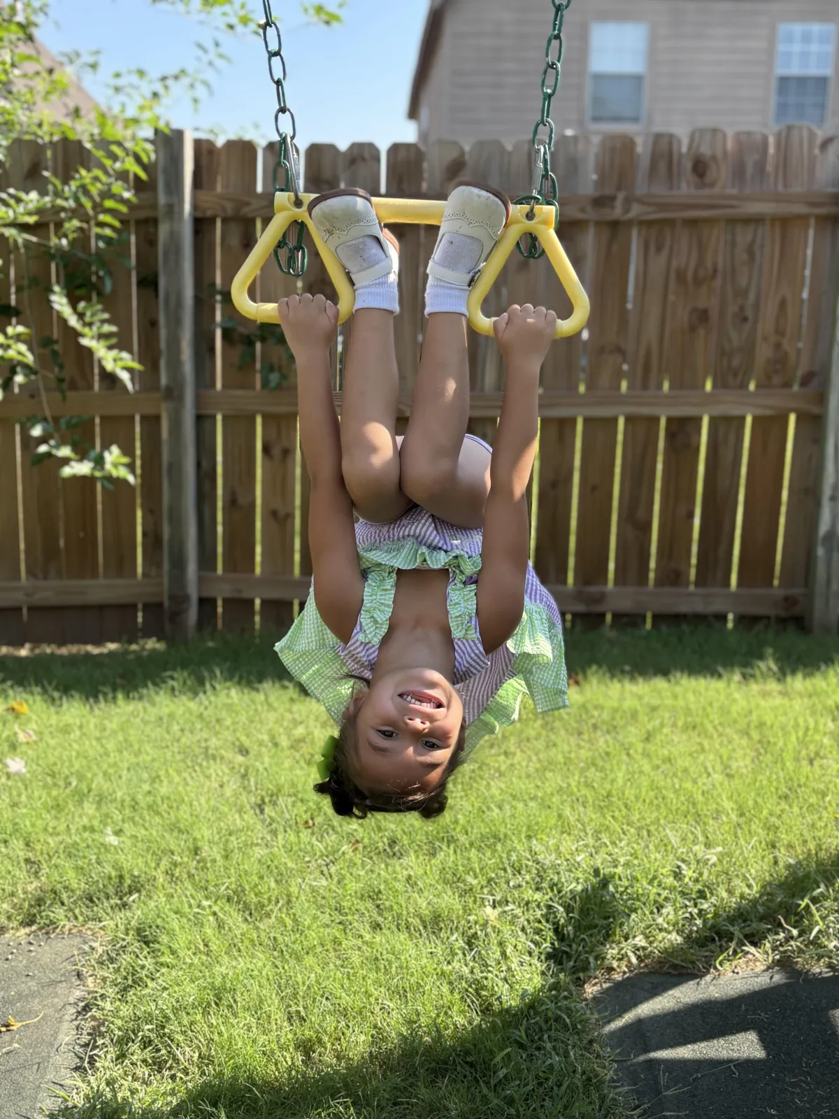 Child with headset smiles as he engages with laptop