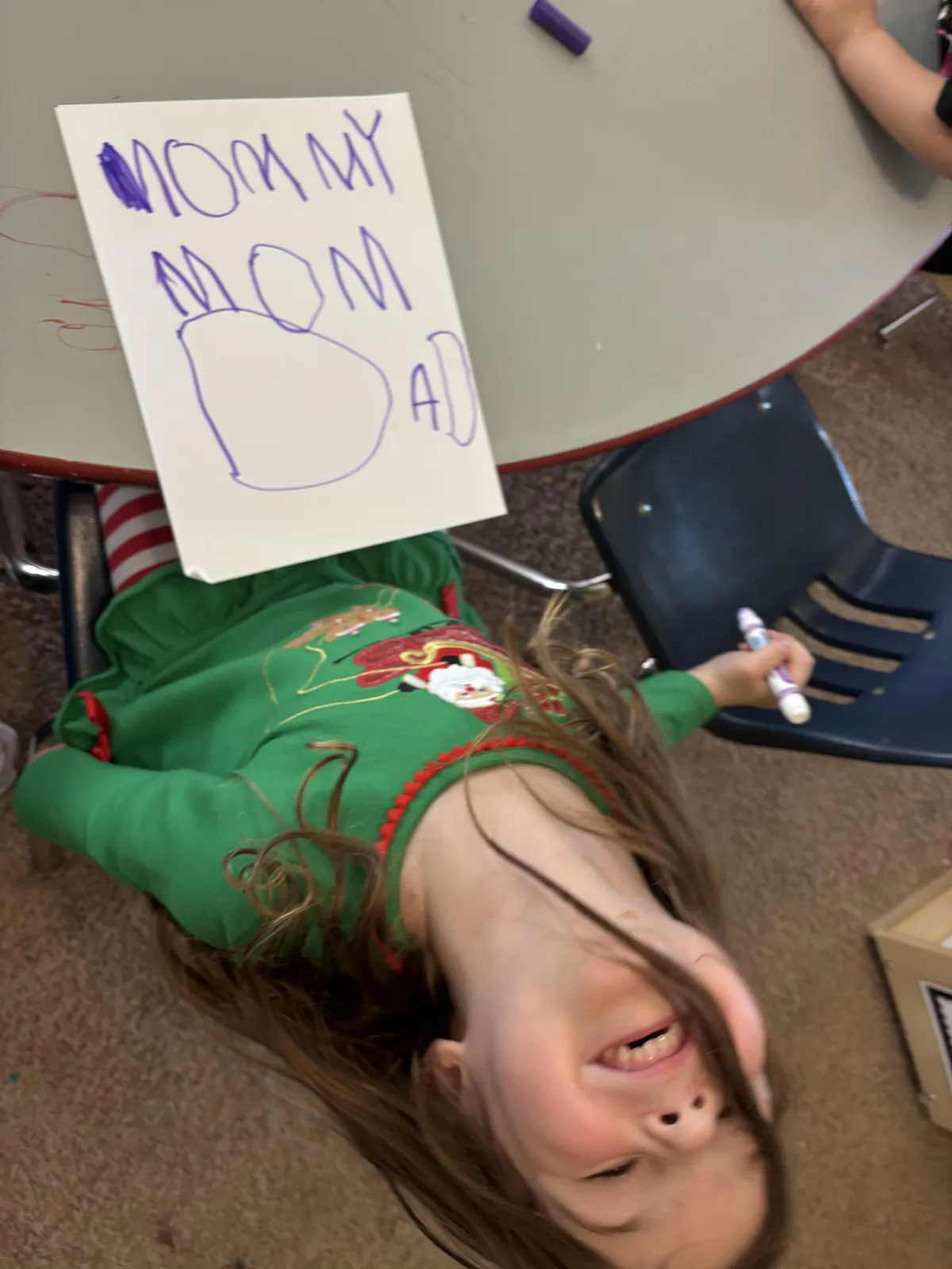 Girl stretches to the side while watching teacher on large screen TV