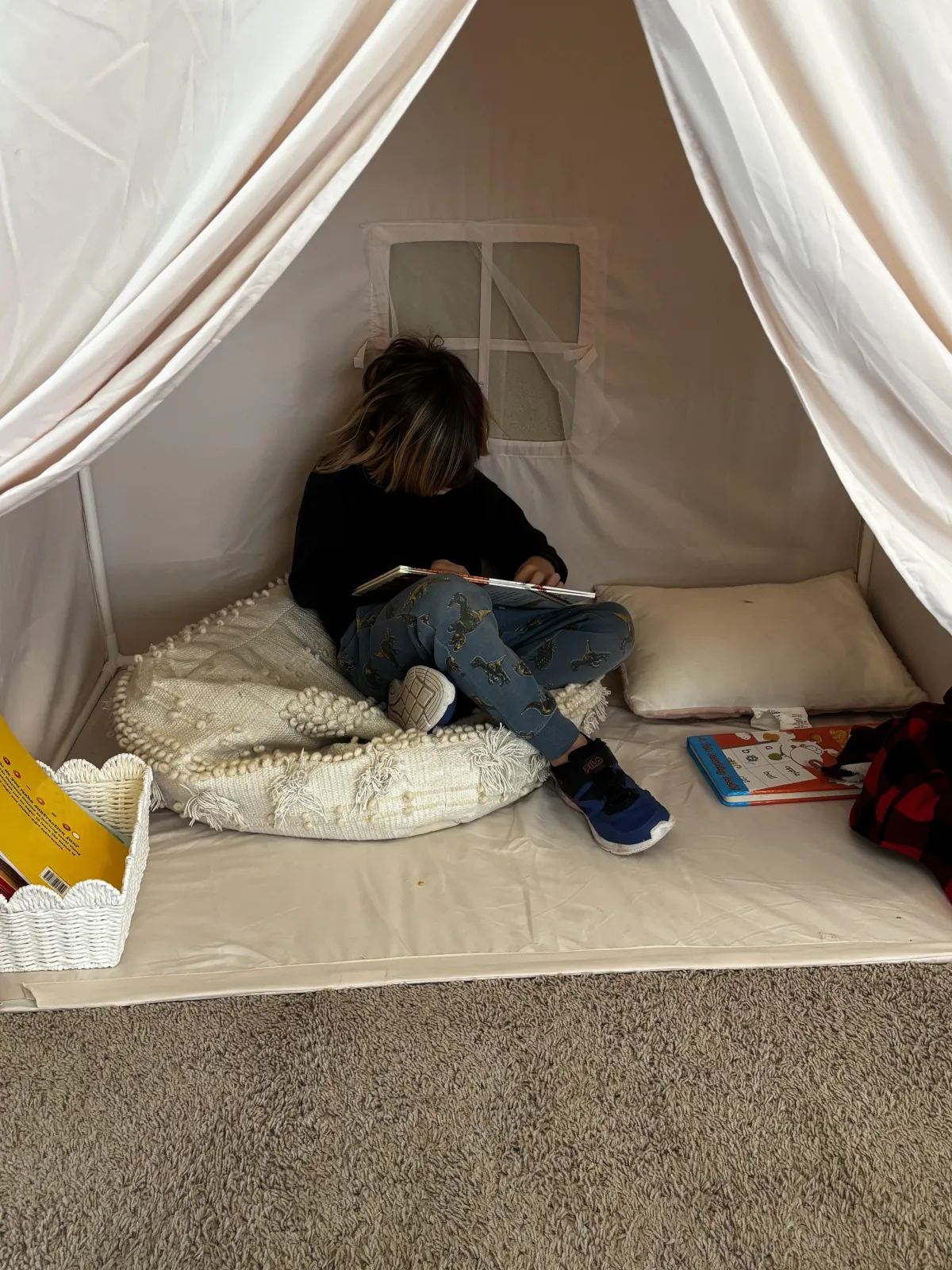 Boy picks paper out of different colored liquids
