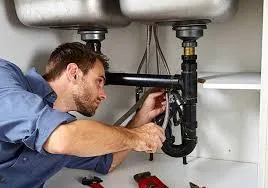 a man standing in a large room with lots of pipes