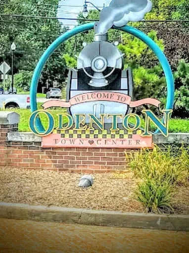 Welcome to Odenton Town Center sign featuring a train engine motif
