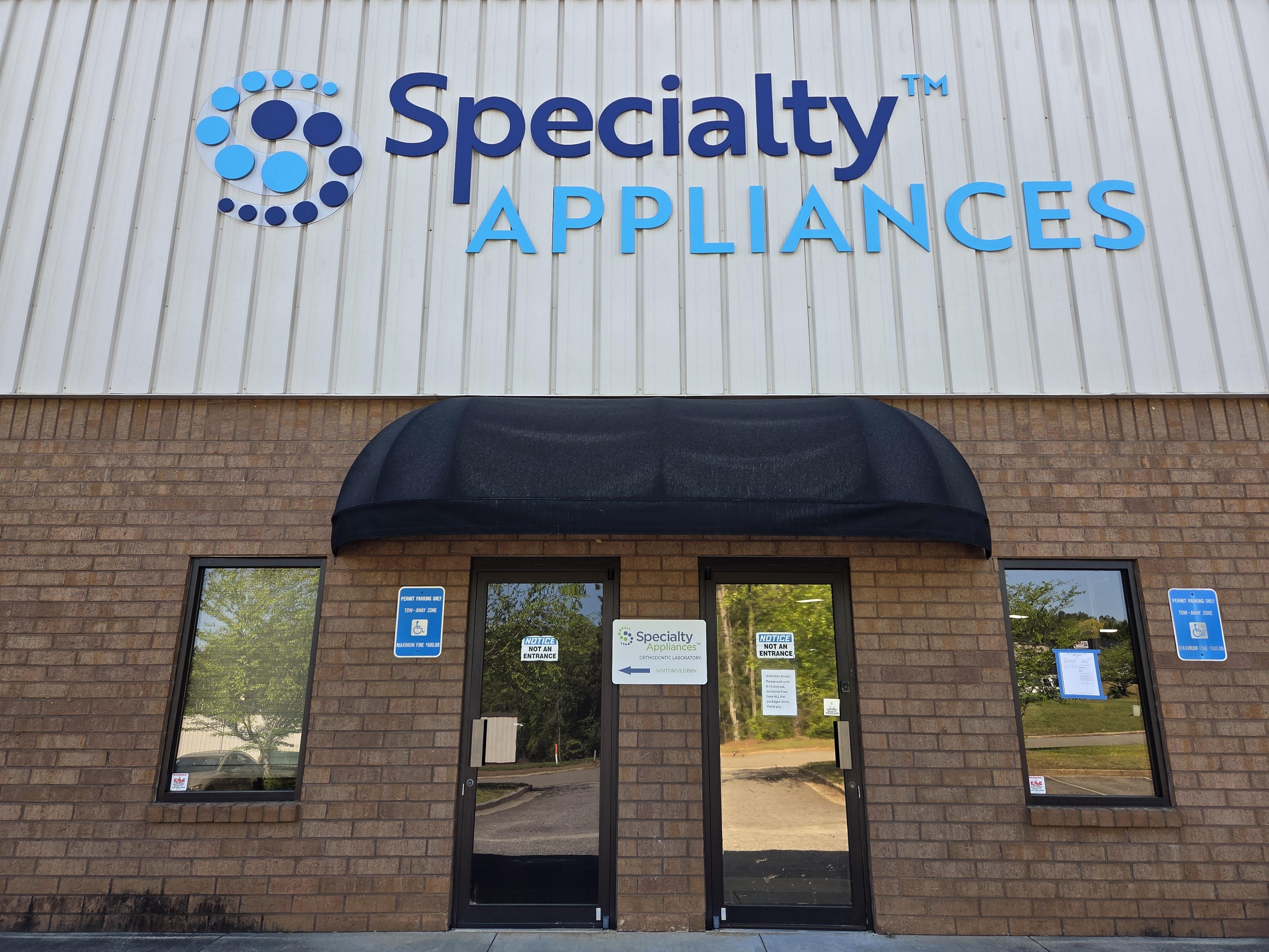 Large blue and white channel letter building sign for Specialty Appliance, custom commercial exterior branding in the Cumming, GA area.