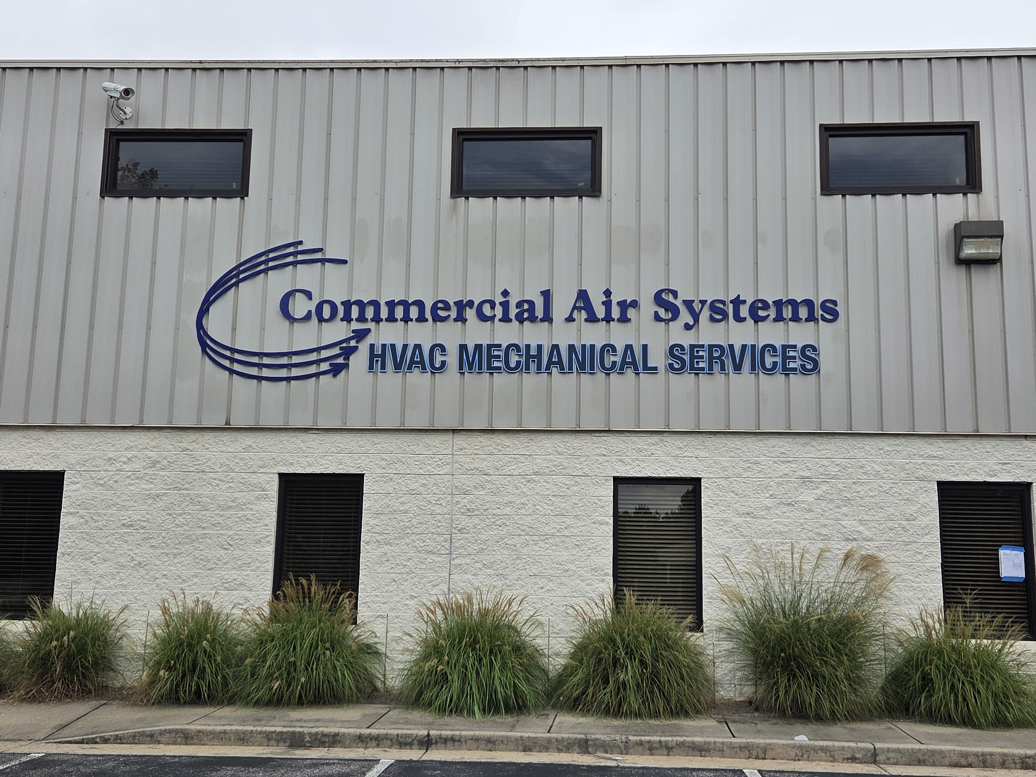 Navy blue dimensional letter building sign for Commercial Air Systems HVAC installed on metal panel exterior wall in Cumming GA by Signary Custom Signs and Graphics
