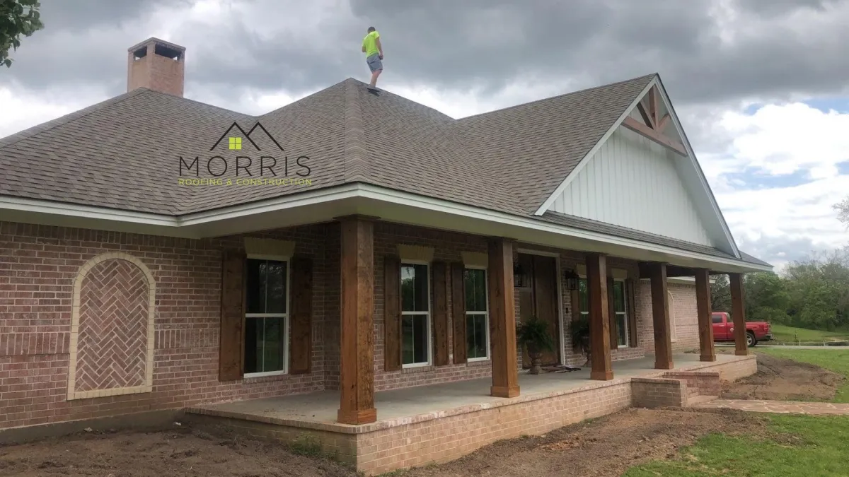 two men carrying a metal sheet