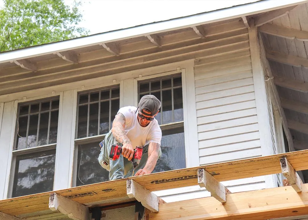 An MBA Roofing professional repairing a roof 
