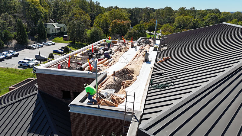 An MBA Roofing professional repairing a roof