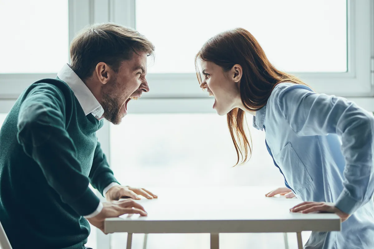 Couple discussing a disagreement calmly while one partner listens