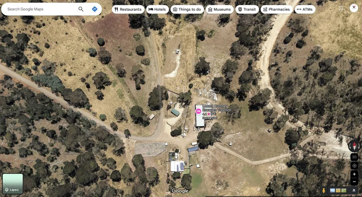 aerial photography of man standing on hill