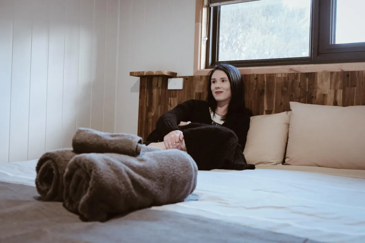 person at peak of mountain carrying red backpack