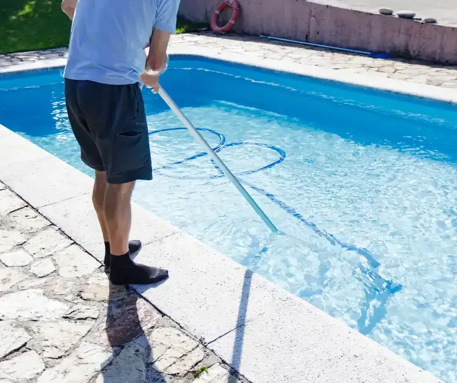 Man Cleaning Pool