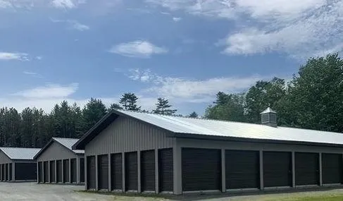 Close-up side view of storage units showcasing the structure and metal roll-up doors at Olsen's Properties