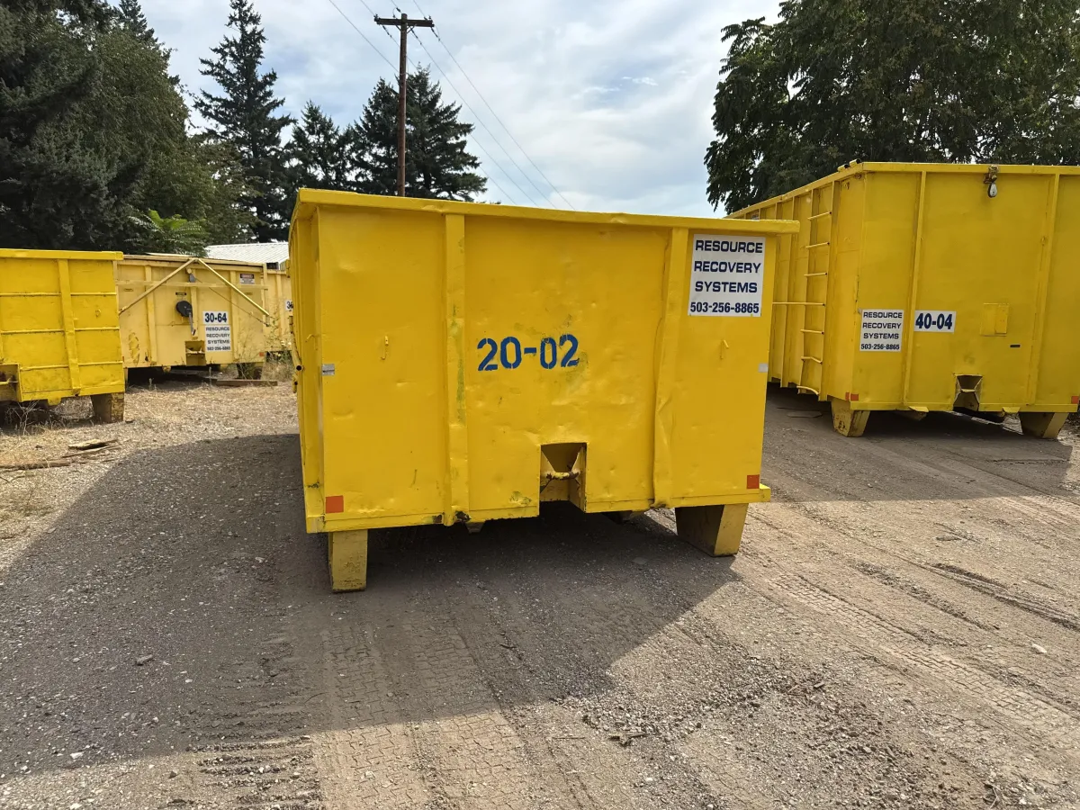 Resource Recovery Systems hauling truck delivering dumpster for residential clean-up in Gresham