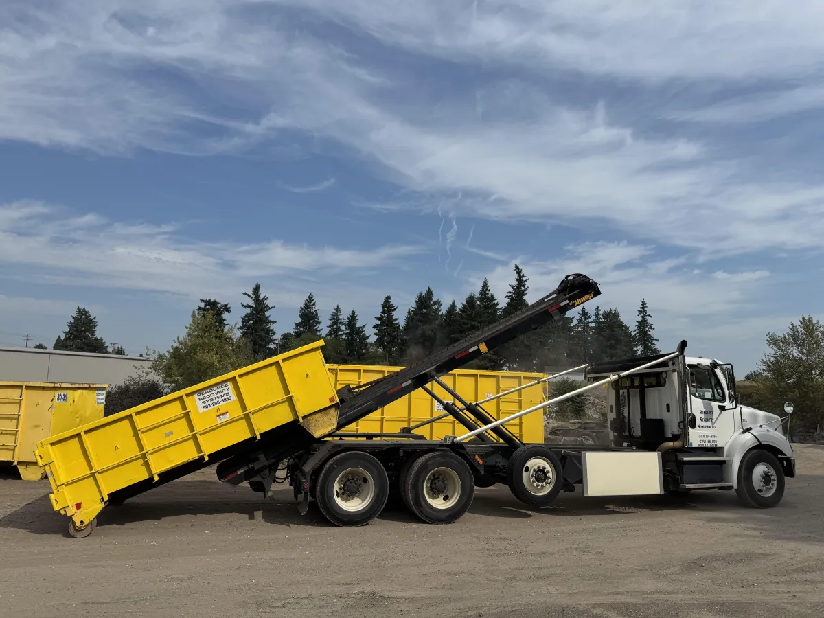 Local family-owned Portland dumpster rental – RRS roll-off truck in action