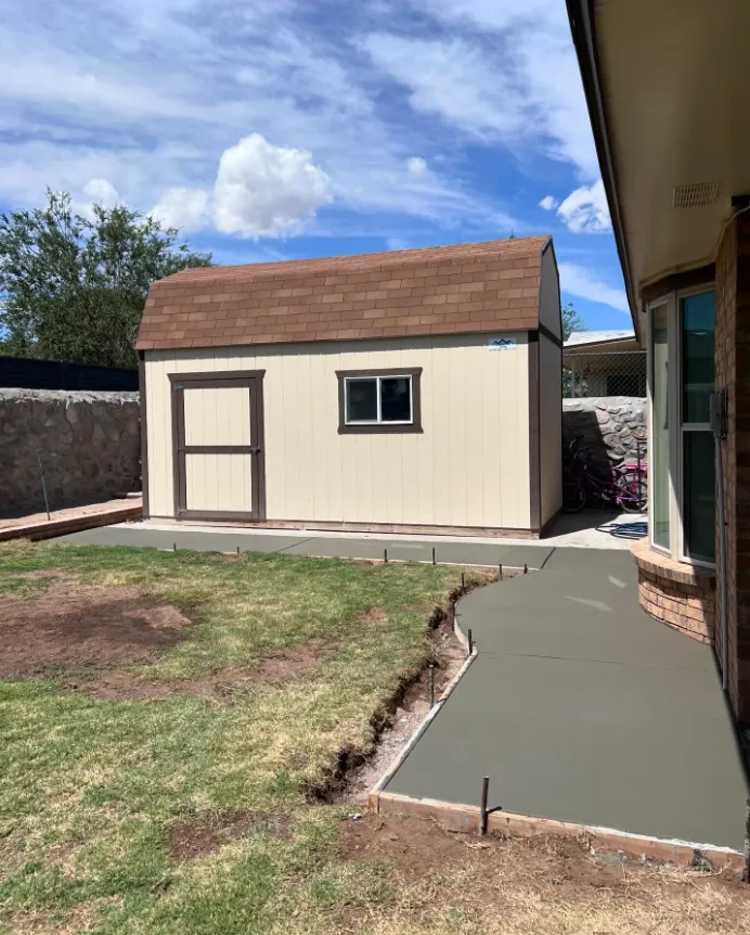 New concrete walkway connecting house and storage shed El Paso