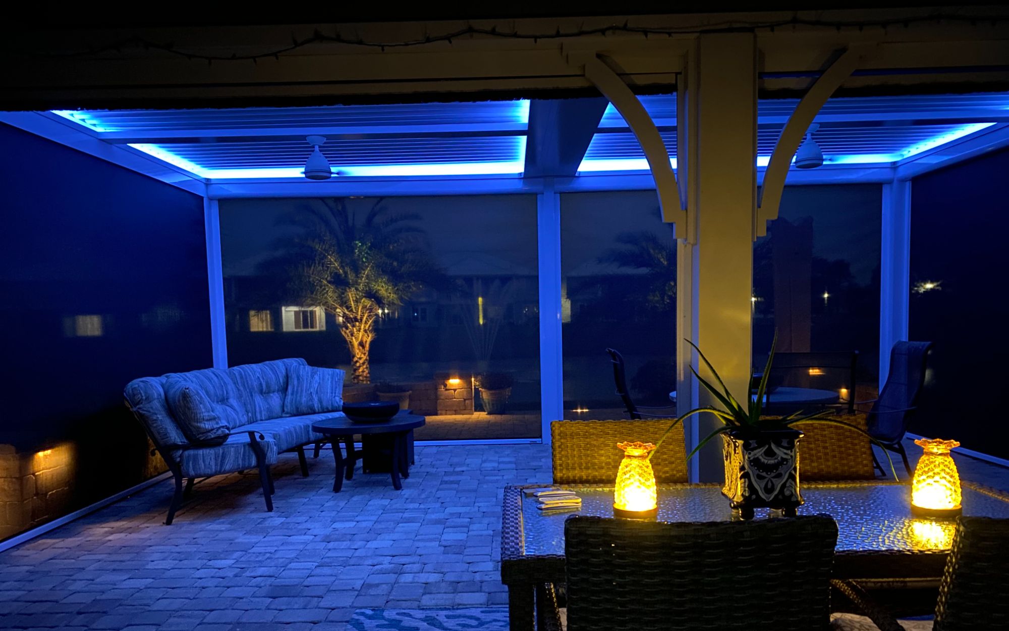 StruXure pergola with blue LED lighting luxury outdoor entertainment space Northeast Florida night