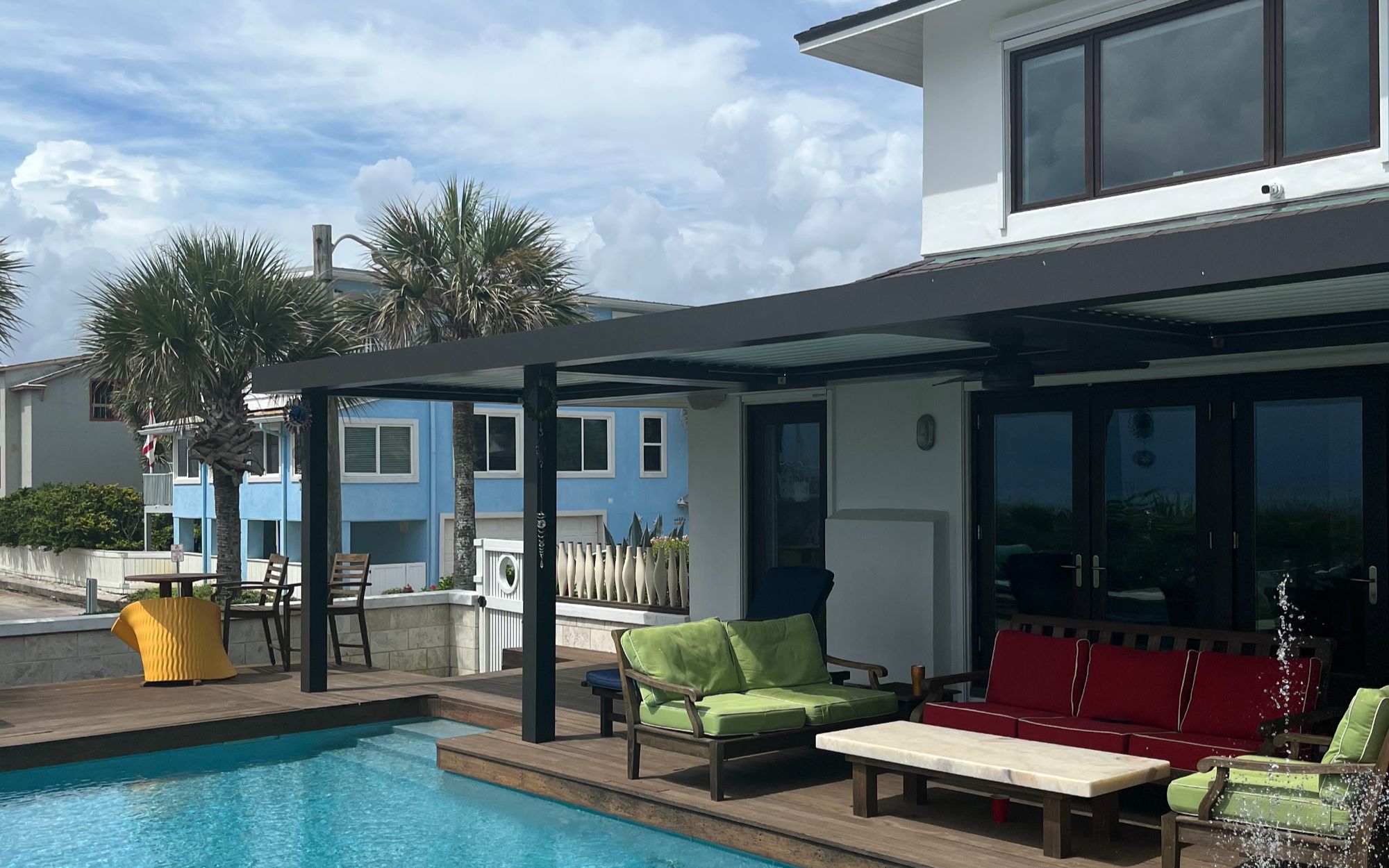 StruXure pergola over pool area tropical landscaping outdoor seating Northeast Florida