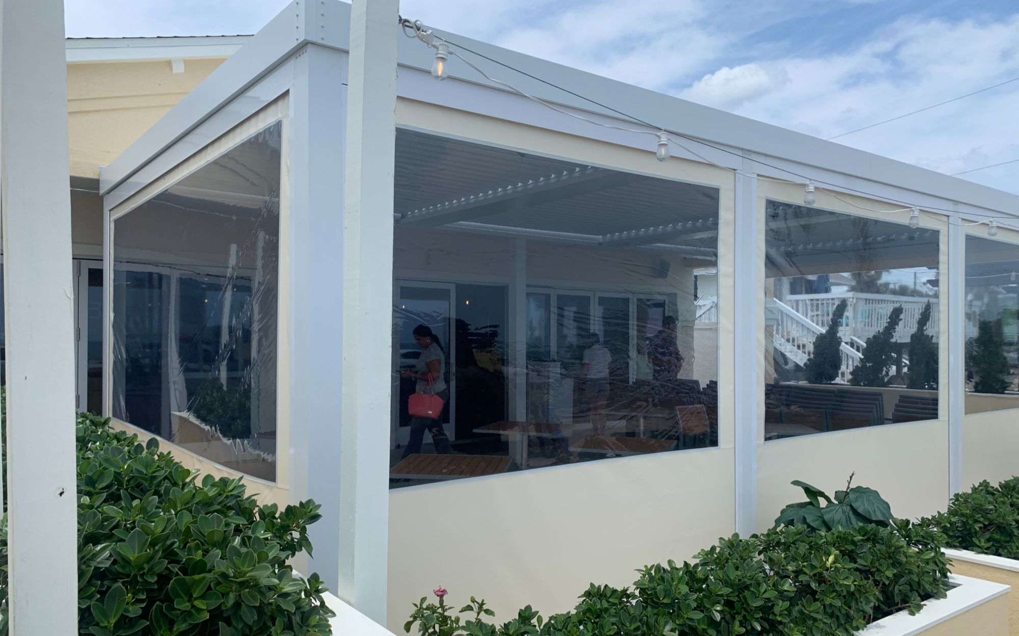 White StruXure pergola over pool screened enclosure modern Florida residential home Titan Outdoor Solutions