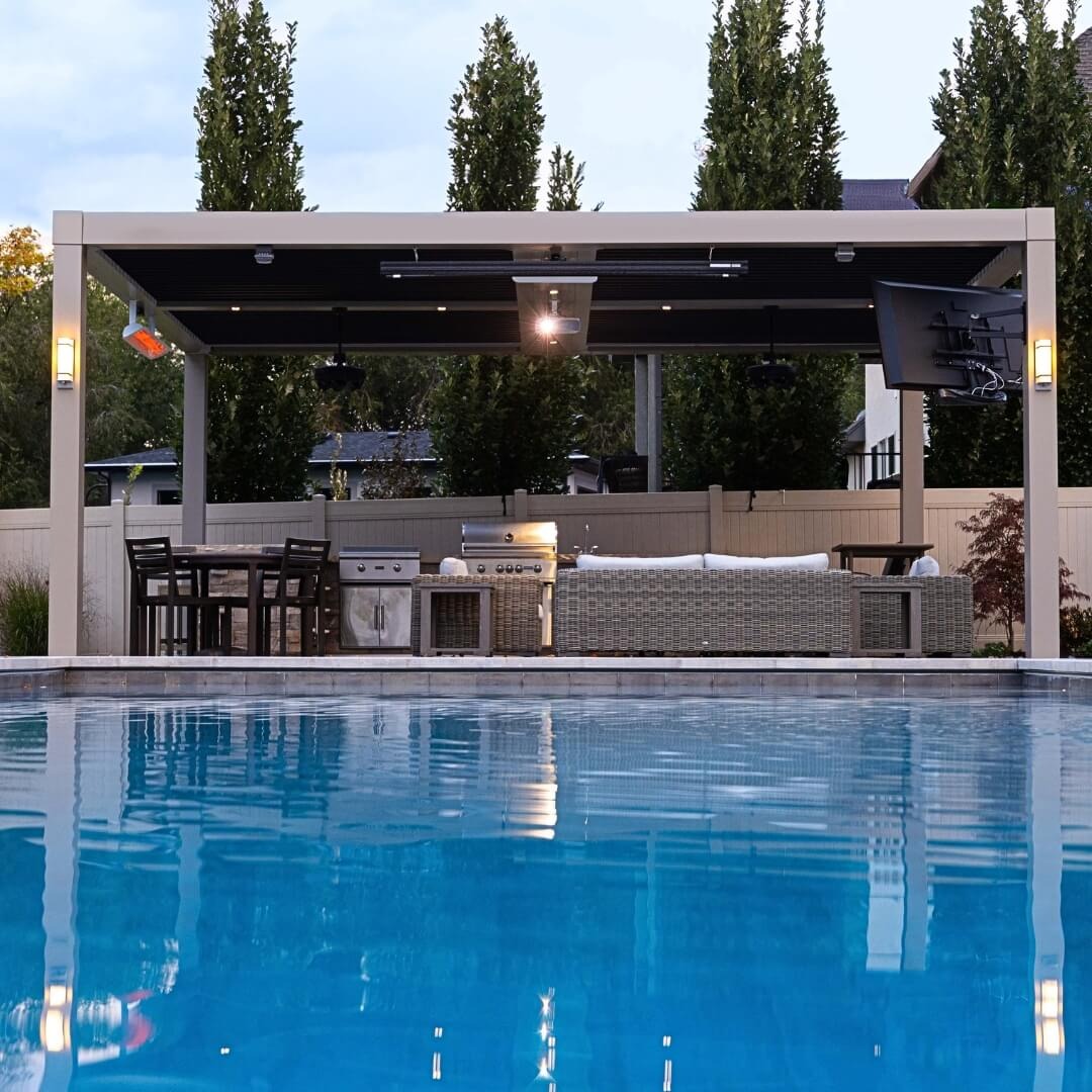 Poolside outdoor kitchen and bar area with motorized pergola for all-weather entertaining