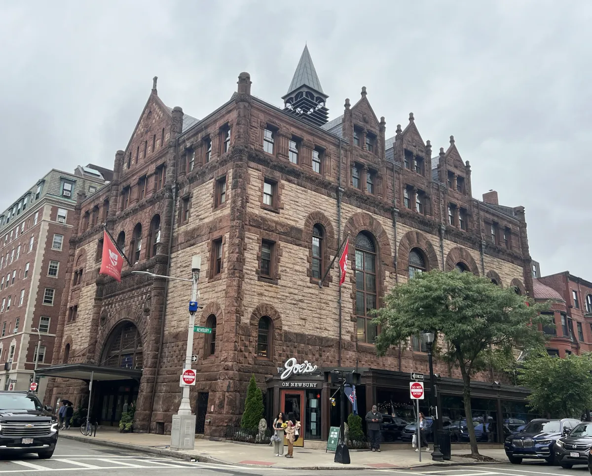 Exterior view of Kingsley Montessori School’s building on Exeter Street in Boston, a large historic stone building photographed from street level.