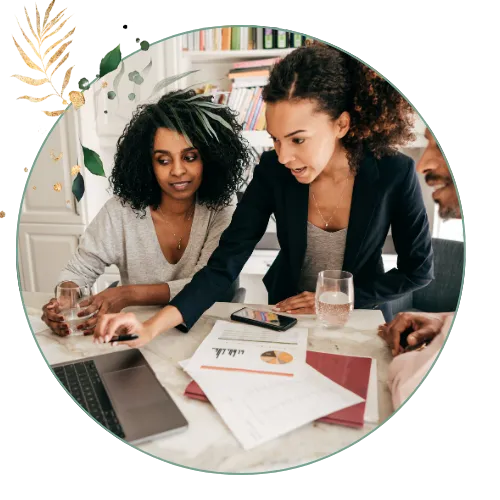 2 woman looking at laptop