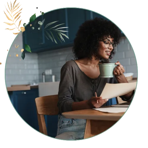 Woman holding coffee mug looking documents