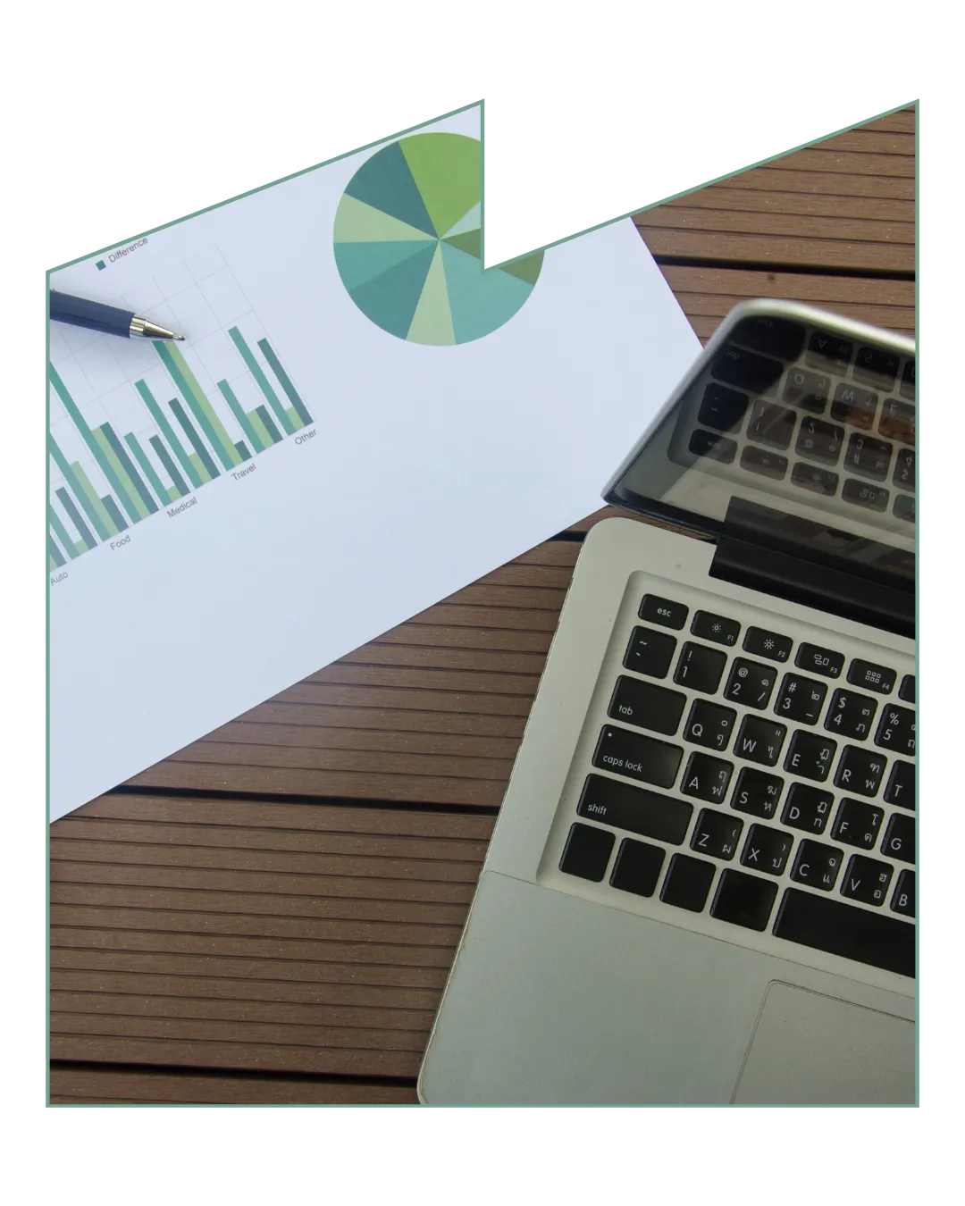 Laptop on desk with documents