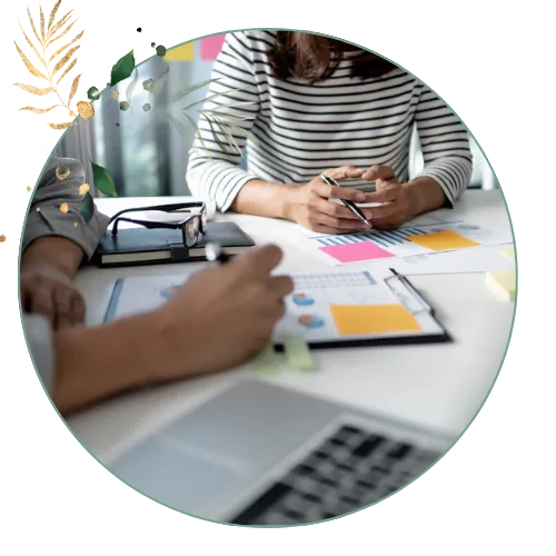 2 woman working on documents at desk