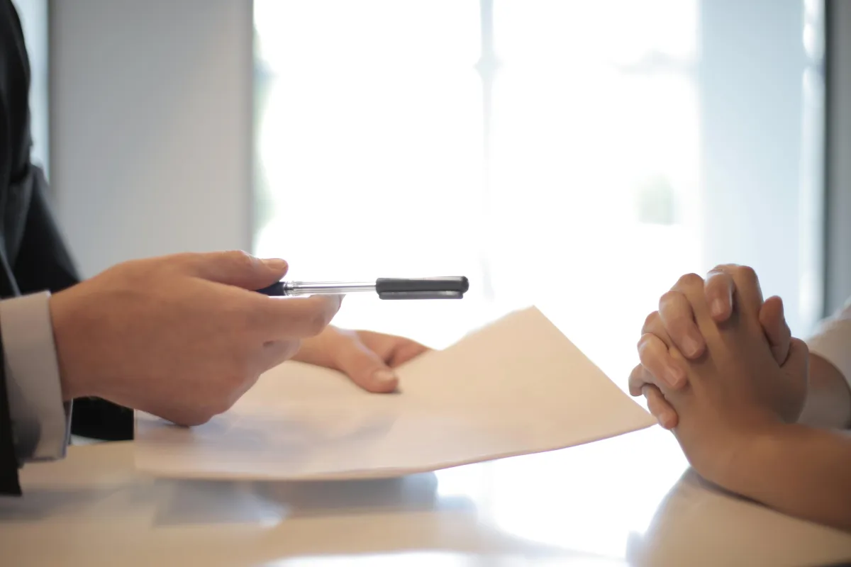 Person explaining something to other person while sitting at table