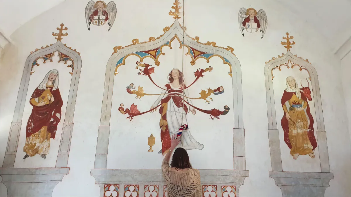 Woman reaching toward a fresco of Mary Magdalene with dragons, symbolizing her bloodline, divine femininity, and spiritual awakening.