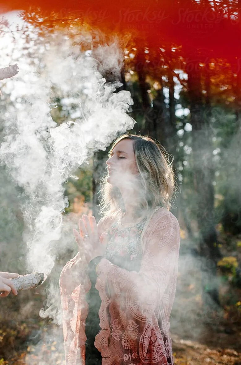 Woman immersed in sacred smoke ritual, connecting to divine feminine energy, spiritual cleansing, and the path to inner healing and deep embodiment.