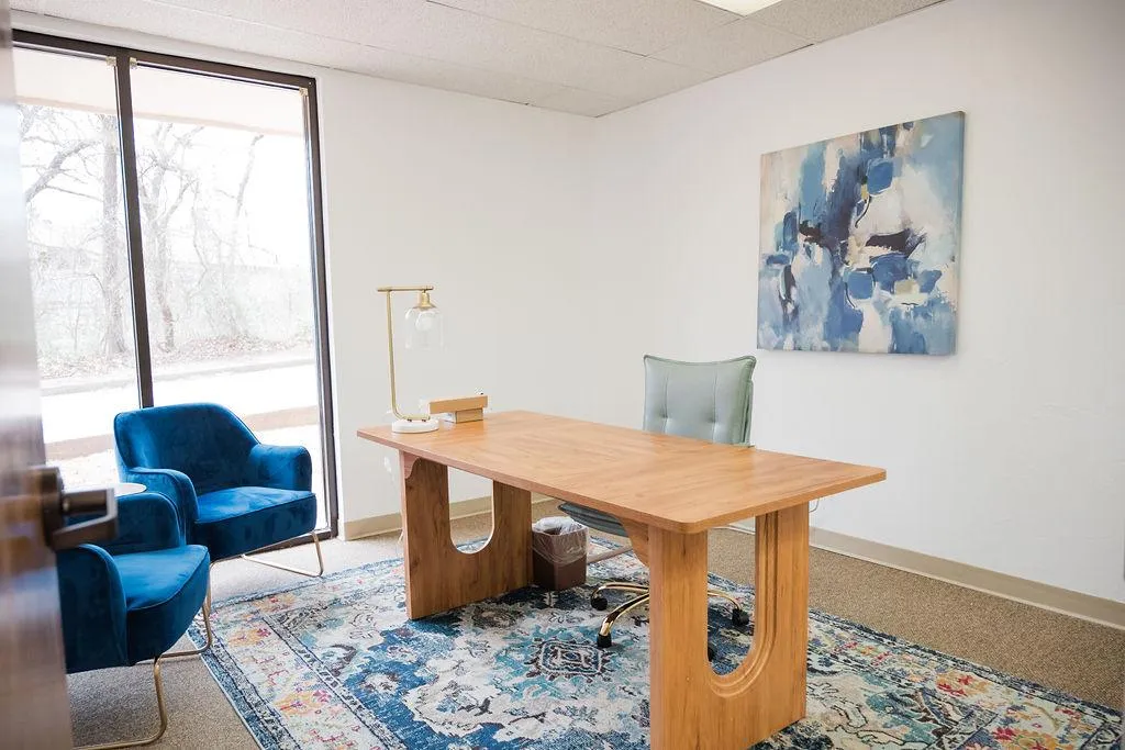 a living room filled with furniture and lots of plants