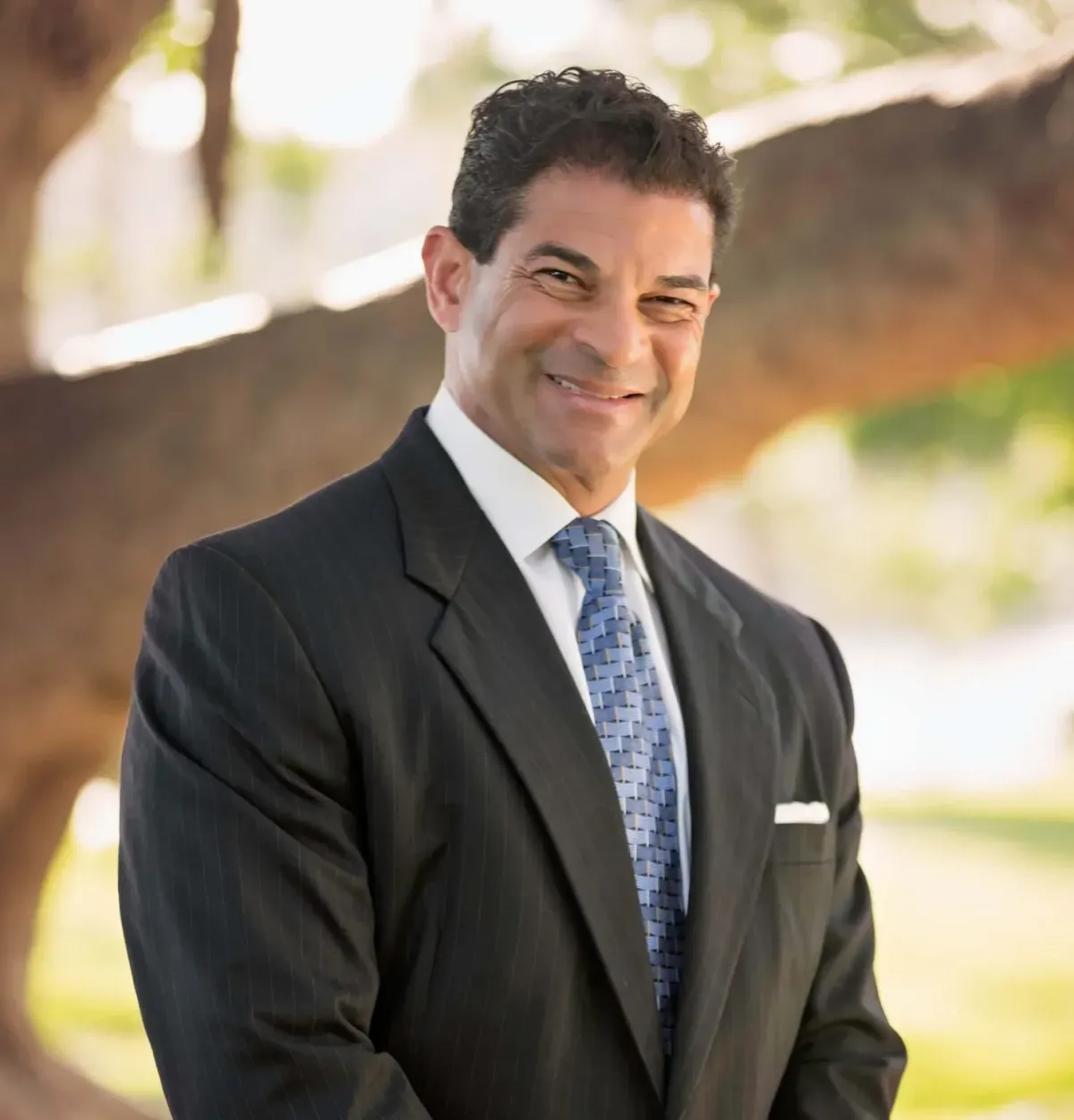 a silver and gold object with a reflection in the water