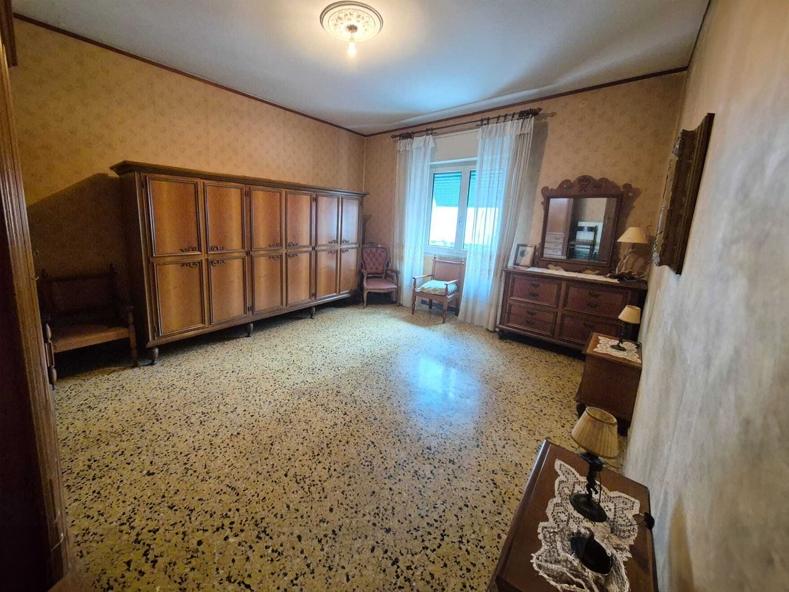 Private home office with custom wood shelving, modern art, and a large window offering panoramic urban views. 3:2 aspect ratio.