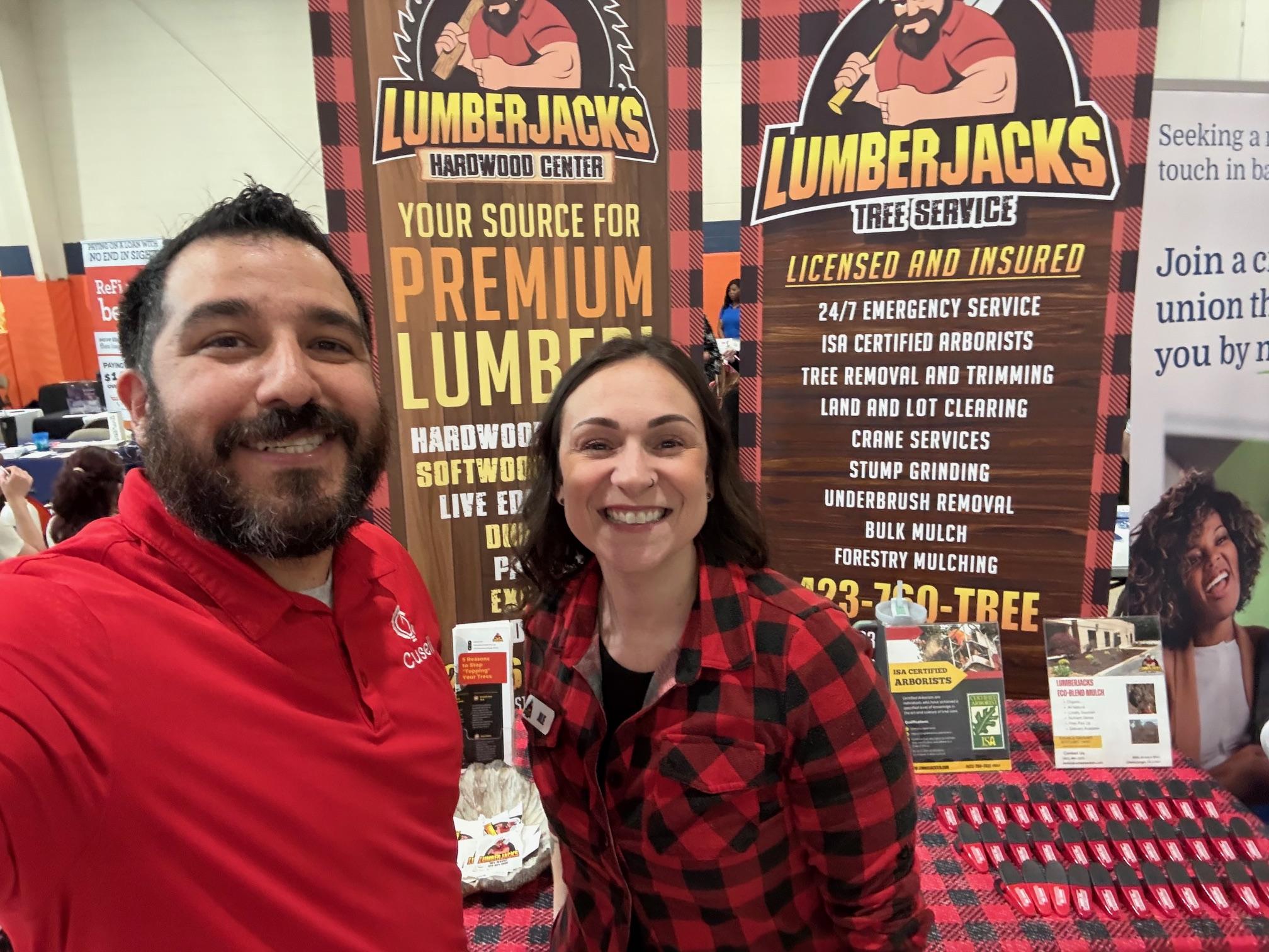 A Chattanooga storefront with digital signage, a business owner using a tablet to interact with customers, and a cityscape in the background. The scene is lively, blending traditional and digital business elements in a bright, inviting style.