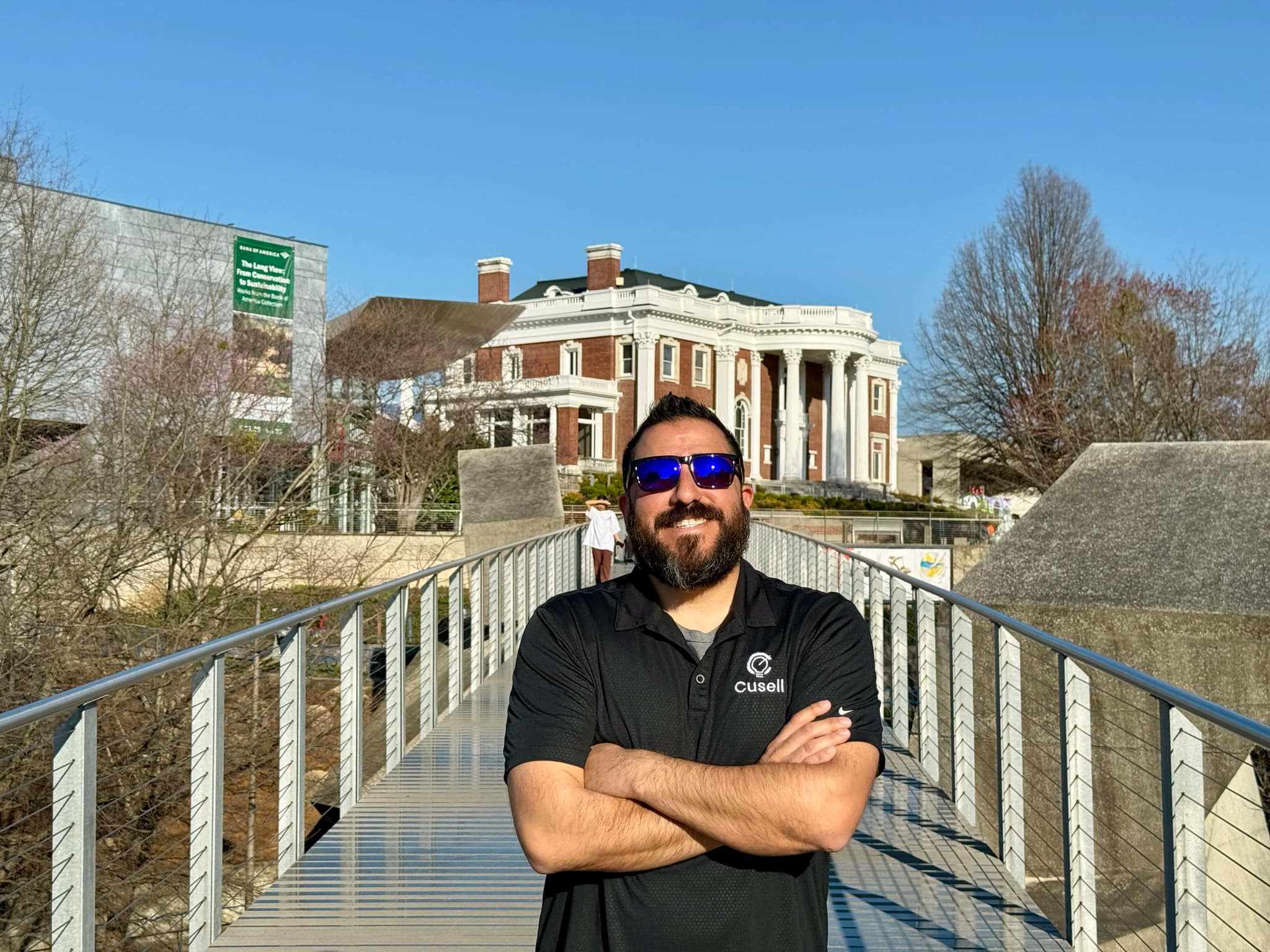 A Chattanooga business leader shaking hands with a consultant in a bright, welcoming office, both smiling and confident. The background features subtle branding elements and a sense of partnership and progress.