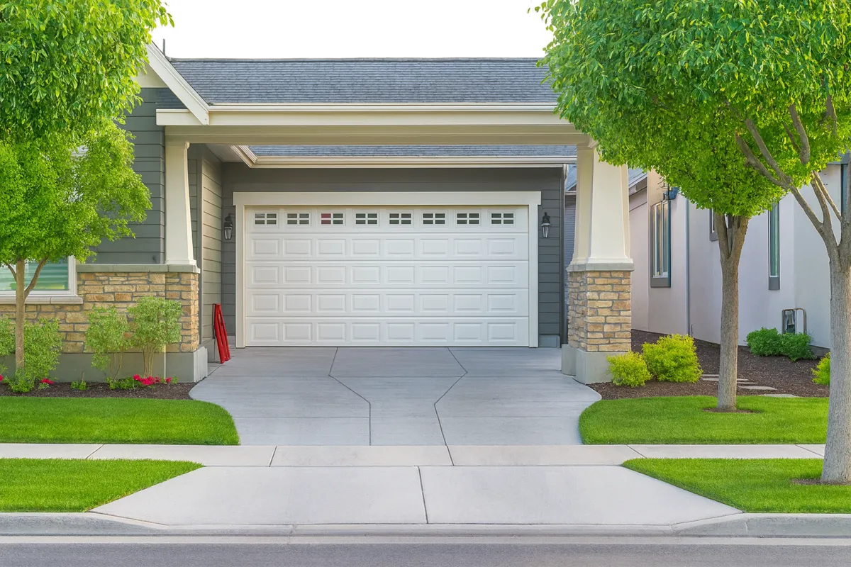 concrete driveway in front of the black house
