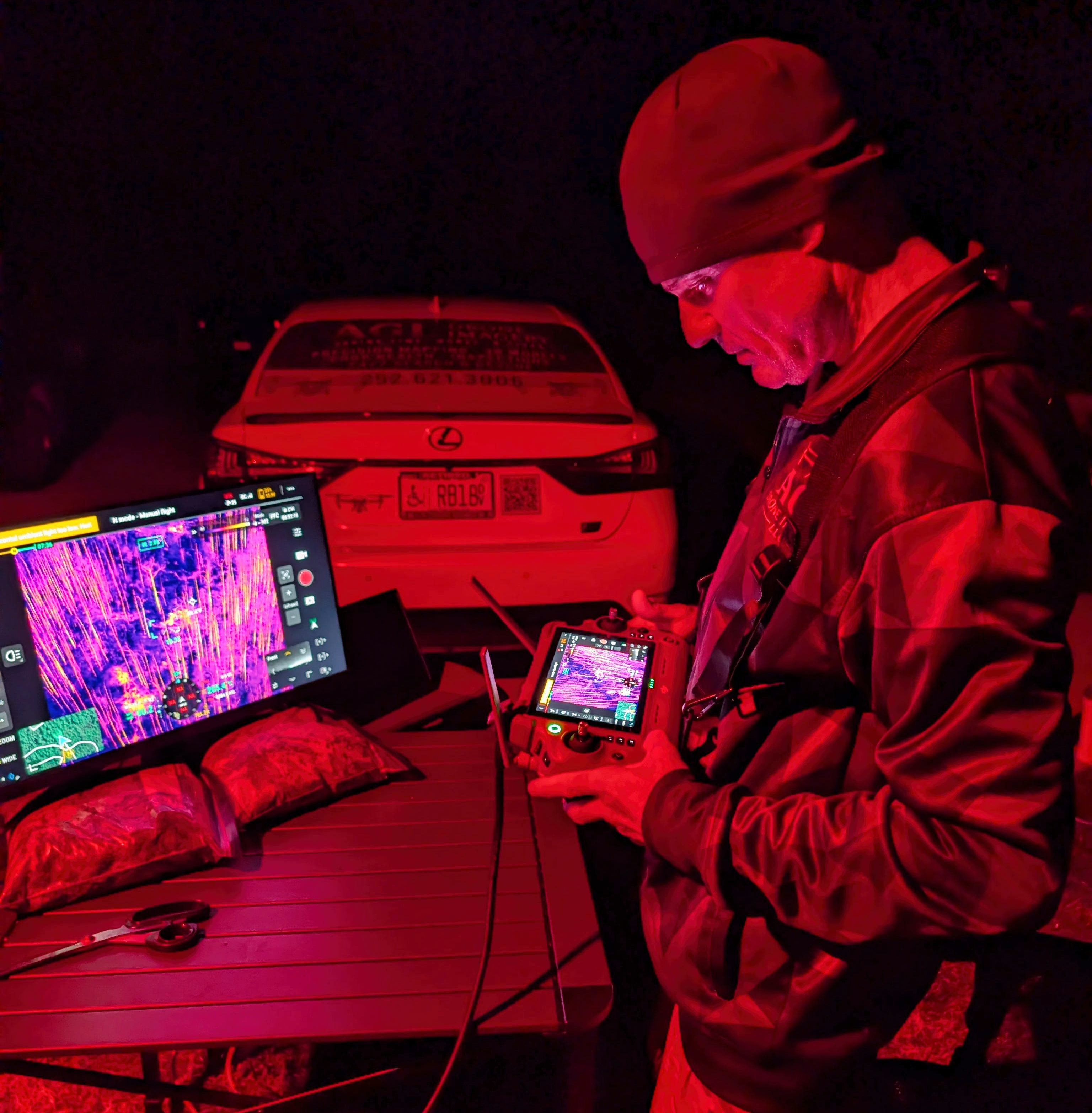 Nighttime operational support personnel reviewing drone imagery