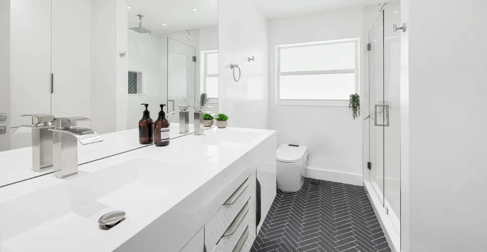 Bathroom renovation featuring double vanity, walk-in shower, and freestanding soaking tub