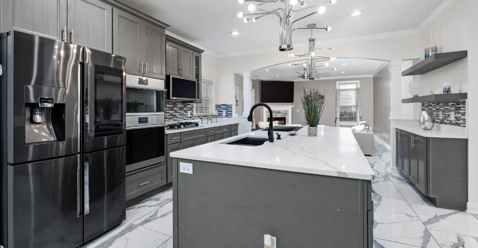 Modern kitchen remodel with white cabinets, granite countertops, and stainless steel appliances