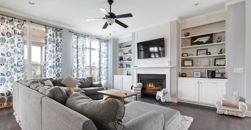 Living room interior remodel with updated windows, fireplace, and natural light