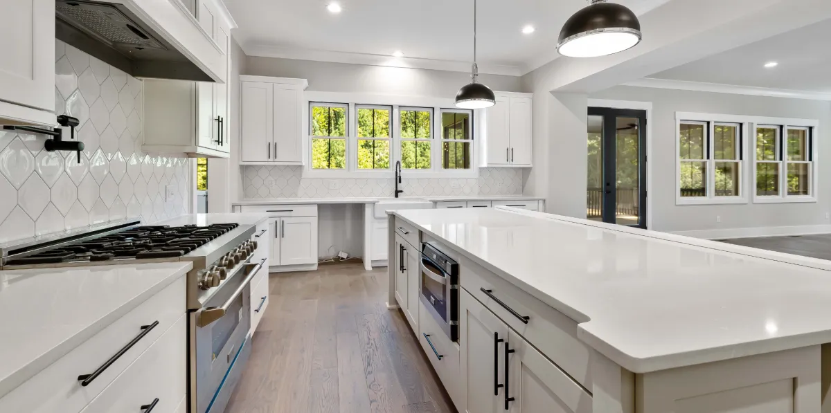 Custom kitchen renovation with new cabinetry, countertops, lighting, and open layout design